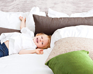 A boy rests in anti-microbial bedsheets.