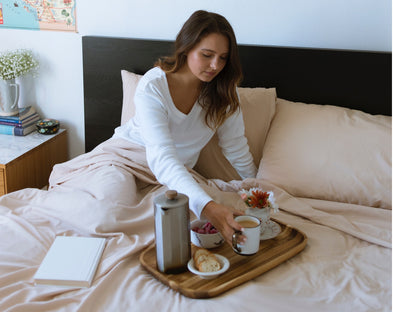 A woman rises from a good night’s sleep.