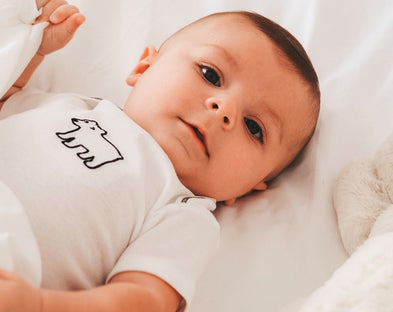 A baby in PeachSkinSheets. How to handle postpartum night sweats.